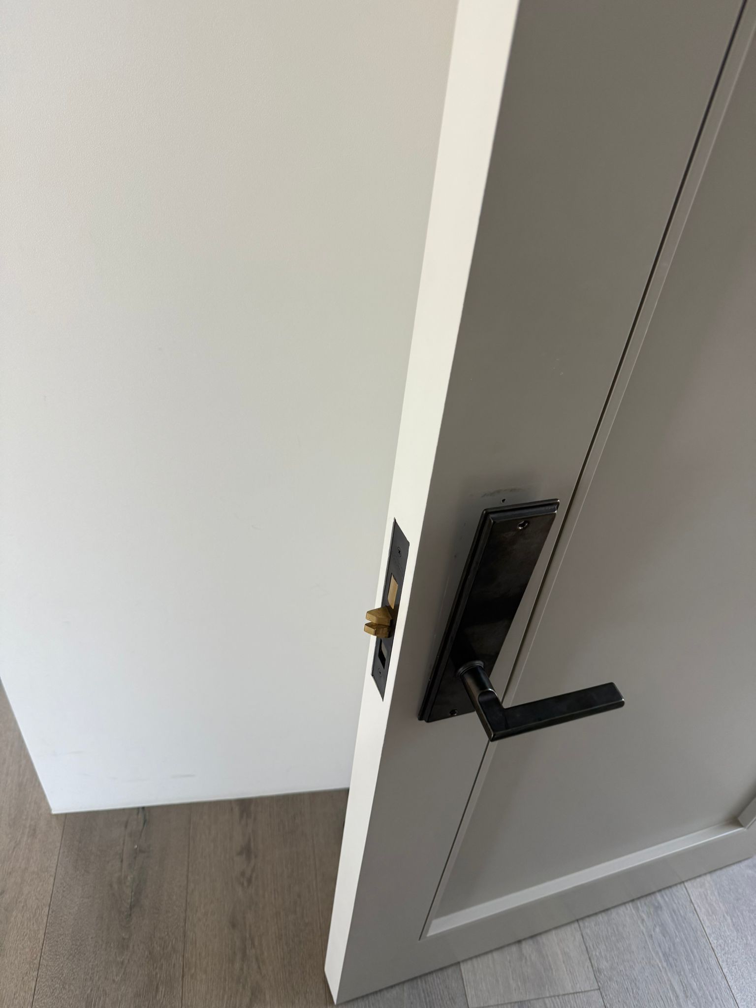 Keywise Locksmith black lever handle and deadbolt installed on a modern interior door in Orange County, CA